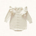 Ivory knit romper with ruffled shoulders, front view