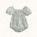 Blue toile print romper with smocked bodice, front view