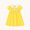 Bright yellow dress with white Peter Pan collar, front view