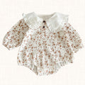 Cream floral romper with white ruffled collar and puff sleeves, front view