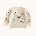 Ivory knit sweater with 3D floral appliqués, front view