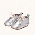 Metallic silver baby shoes with brogue-style perforations