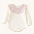 Cream knit romper with blush pink scalloped collar, front view