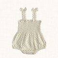 Polka dot romper with smocked bodice and bow straps, front view