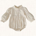 Ivory romper with floral embroidery and ruffled neckline, front view