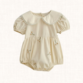 Cream romper with daisy embroidery and oversized Peter Pan collar