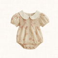Floral romper with smocked bodice and white Peter Pan collar, front view