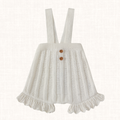 Knit romper with vertical pleats and wide shoulder straps, front view