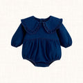 Navy denim romper with oversized ruffle Peter Pan collar, front view