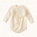 Ivory knit romper with openwork pattern and waist tie, front view
